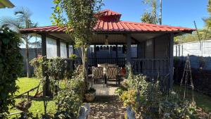 a gazebo with a table and chairs in a garden at Polokwane Luxury Guest House in Polokwane