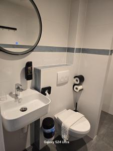 a bathroom with a sink and a toilet and a mirror at The Crown Hotel in Amsterdam +58 photos