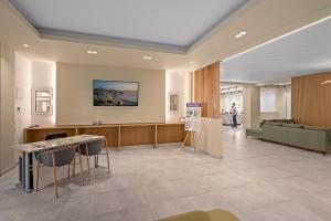 Eine Lobby mit Wartebereich, ausgestattet mit Stühlen und einem Sofa. in der Unterkunft Fragiskos Hotel in Matala + 34 Fotos