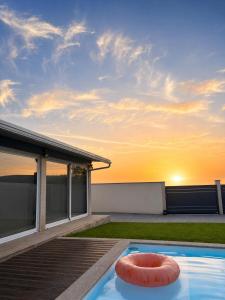 a swimming pool with a red ring in a backyard at Michel's house in Esposende