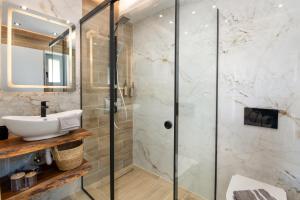 a bathroom with a sink and a shower at TS Luxury villa in Velianitátika +26 photos