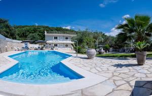 a villa with a swimming pool and a house at La Sirenetta Residence in Syvota