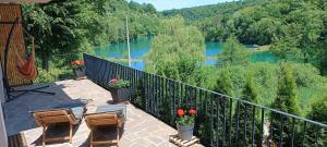 a balcony with chairs and a view of a river at Rivera House Mrežnica in Generalski Stol