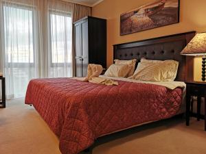 a bedroom with a large bed with a red blanket at Royal Beach Premium Residence- Sunny Beach in Sunny Beach +38 photos
