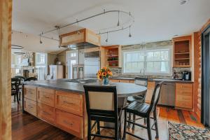 a kitchen with a table and some chairs in it at Art & Soul Main House in Lyndhurst +37 photos