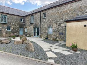 a stone building with rocks in front of it at The Shippon at RoseHip in Launceston