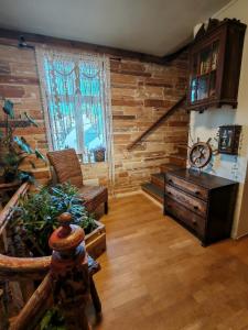 a living room with a wooden wall at Timber loft in Vigra +17 photos