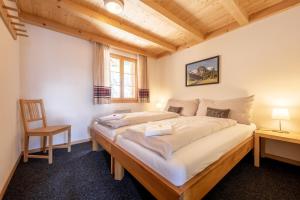 a large bed in a room with a wooden ceiling at Tällihütte in Gadmen