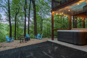 a screened in porch with blue chairs and a house at Bear Tracks Cottage in Nellysford +43 photos