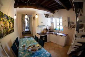 a kitchen with a table and a dining room at Castè Style near Cinque Terre in Riccò del Golfo di Spezia