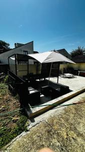 a patio with an umbrella and a table and chairs at Camping car Paris in Savigny-le-Temple