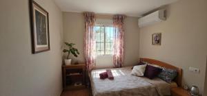 a small bedroom with a bed and a window at Casa Rural Villa Arcadia in Corvera