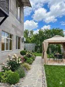 a garden with a patio and a gazebo at Bank Hotel in Yeghegnadzor