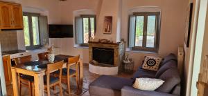 a living room with a couch and a fireplace at Vrisi House in Kiparission
