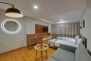 a hotel room with a bed and a table at Click Collection Aster, Raja Park - Jaipur in Jaipur