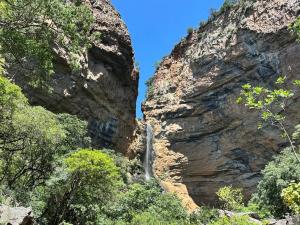 a waterfall in the middle of a mountain cliff at Glen Avon Farm in Somerset East