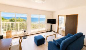 a living room with a view of the ocean at SORA Blue House, 海辺の隠れ家, ペットBBQ可, 全3寝室&リビングオーシャンビュー,一棟貸切 in Hokota