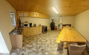 a kitchen with a wooden table in a room at Carla House in Vidolm
