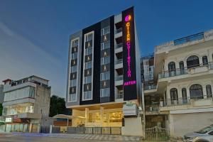 a hotel with a sign in front of a building at Click Collection Aster, Raja Park - Jaipur in Jaipur