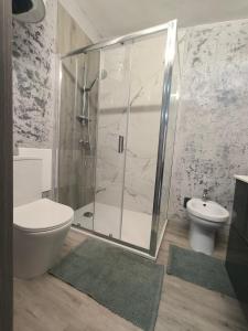 a bathroom with a shower with a toilet and a sink at Villa Topaz in Capoterra +17 photos