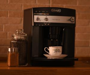 a coffee maker with a cup on a counter at Casa Lörinczi in Sighişoara