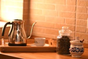 a tray with a tea kettle and a cup on a counter at Casa Lörinczi in Sighişoara +10 photos