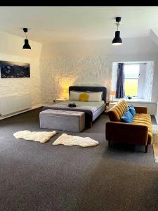 a living room with a bed and a couch at Hartfield House Hostel in Applecross