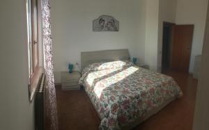 a bedroom with a bed with a quilt on it at Casa Vacanze Elisa in Manciano