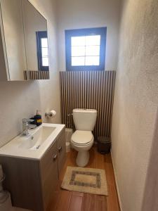 a bathroom with a toilet and a sink and a mirror at Natalie’s House in Alexandroupoli +14 photos