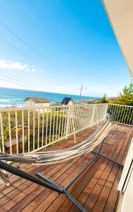 a hammock on a deck overlooking the ocean at SORA Blue House, 海辺の隠れ家, ペットBBQ可, 全3寝室&リビングオーシャンビュー,一棟貸切 in Hokota