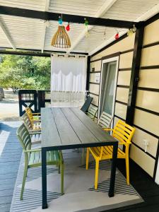 a wooden table and chairs on a patio at Mobile home SIMS in Biograd na Moru
