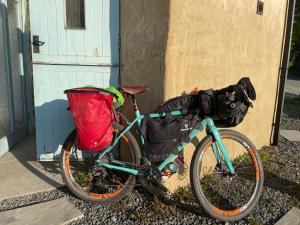 a bike parked next to a building with a bag on it at The Shippon at RoseHip in Launceston