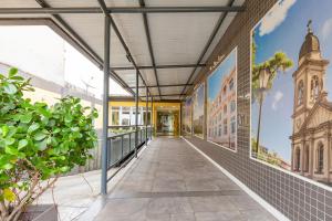 a corridor of a building with a mural of a city at Tri Hotel Smart Santa Maria in Santa Maria