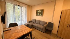 a living room with a couch and a table at Sun Estate Ureki in Ureki