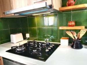 a kitchen with a stove and a green tiled wall at Casa Flor de Taronger in Viladecáns +52 photos