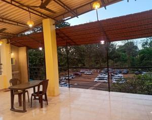 a patio with a table and chairs and a view of a parking lot at Caffe Bombay in Nagaon