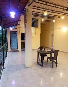 a patio with a table and chairs in a building at Caffe Bombay in Nagaon