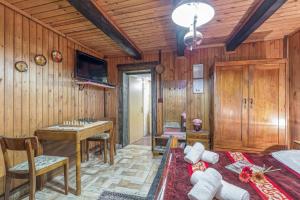 a room with wood paneled walls and a table and a bed at Chalet Birchwood With Hot Tub and Sauna - Happy Rentals in Hum Breznički +22 photos
