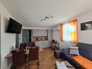 a living room with a blue couch and a table with chairs at Campingpark Rammingen in Rammingen