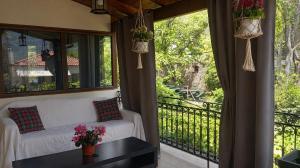 a screened in porch with a couch and a table at Panorea house in Polydrossos
