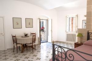 a room with a table and chairs and a bed at 360 view of the Sassi in Matera +4 photos