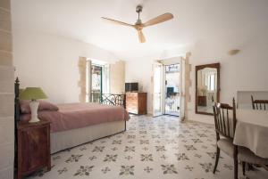 a bedroom with a bed and a ceiling fan at 360 view of the Sassi in Matera