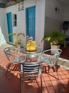 a patio table with two chairs and a yellow bag on it at Guajira Sunset Hostal in Ríohacha