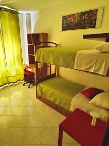 a room with two bunk beds and a table at Golden Hour House in Termoli