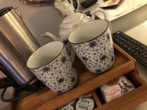 two coffee mugs on a wooden shelf at The Haven in Windermere +16 photos