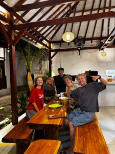 a group of people sitting at a table at Heyho Bungalow in Maluk
