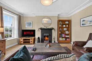 a living room with a fireplace and a table at Castleview in Hillsborough