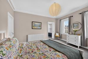 a bedroom with a large bed and two windows at Castleview in Hillsborough