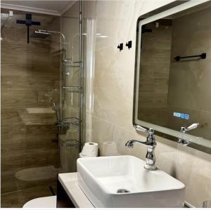 a bathroom with a sink and a shower and a mirror at Villa Katerinaki in Kos +9 photos