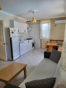 a kitchen and living room with a couch and a table at mavikösk apartement in Dalyan